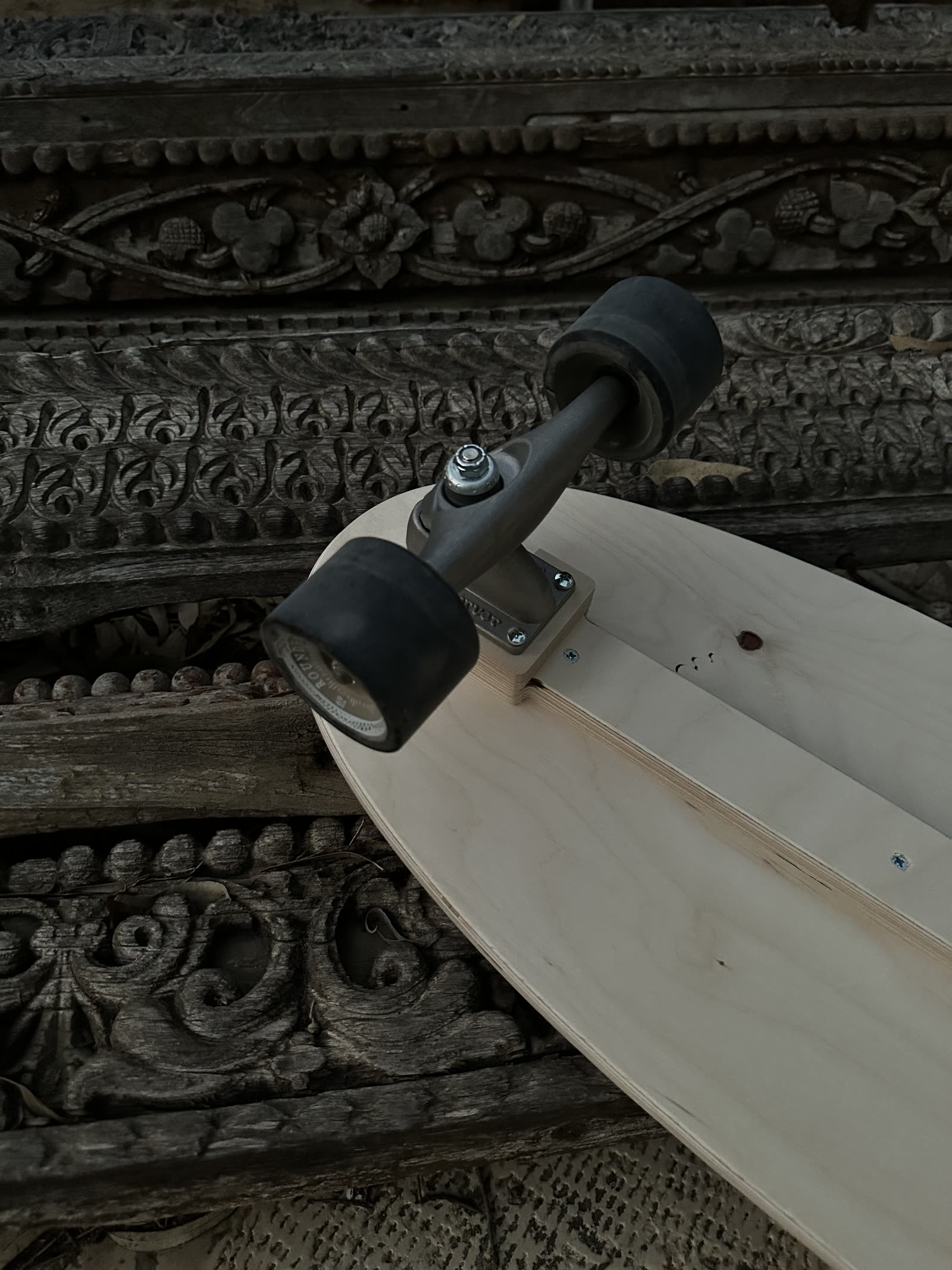Skate truck bolted flush into the wooden connector block on the Olo deck