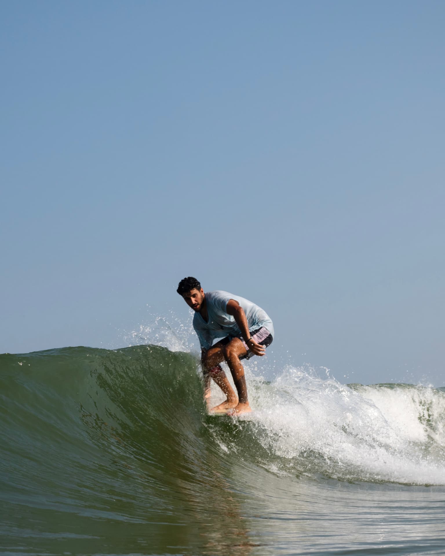 Founder shaping a surfboard in the shaping room